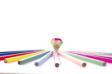 Colored pencils and ring  isolated on white background