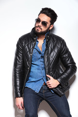Obraz premium man in leather jacket and sunglasses looking to his side