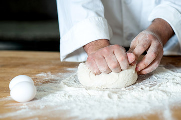 Man kneading dough, closeup shot