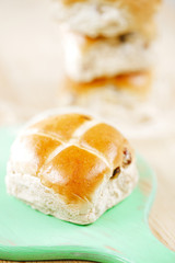 hot cross buns on wooden board, shallow dof