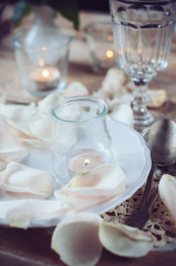 Fototapeta na wymiar vintage table setting with rose petals