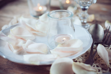 vintage table setting with rose petals
