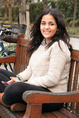 Arabian teen girl with smart phone outdoors