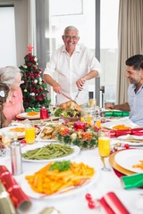 Cheerful family at dining table for christmas dinner