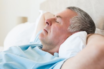 Obraz na płótnie Canvas Senior man sleeping in bed