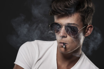 Obraz premium Portrait of handsome man with cigarette