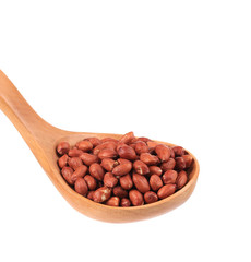 Wooden spoon with peanuts.