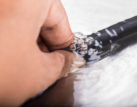 Fototapeta Finding a bicycle inner tube puncture in the water