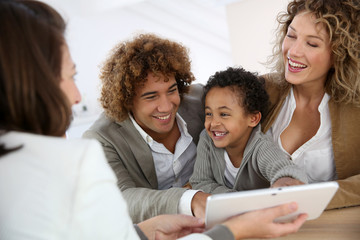 Family meeting real-estate agent for home purchase