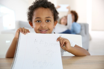 Portrait of little boy drawing with pen