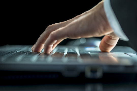 Man Entering Data On His Laptop Computer