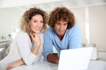 Couple websurfing on laptop computer