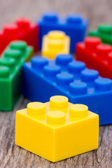 Color plastic  blocks on wooden background