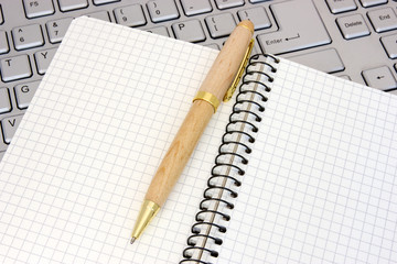 Notebook and pen on the  keyboard