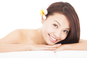 Obraz na płótnie Canvas woman in spa salon lying on the massage desk with towel