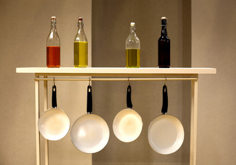 olive oil into different bottles on a shelf against