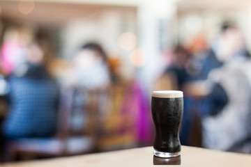 Pint of stout in busy restaurant