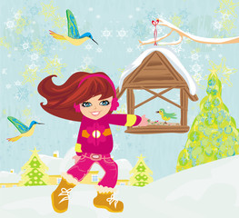 girl feeds the birds in winter