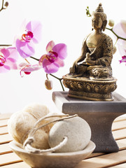 loofah and exfoliating stone with Buddha and sensual orchids