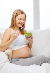 happy pregnant woman eating salad