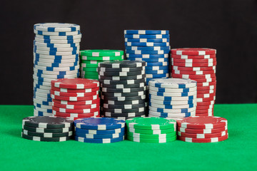 poker chips stack on green table black background