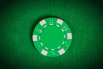 macro green poker chip on table