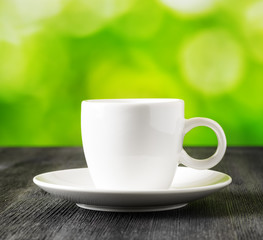 Cup of coffee on nature background