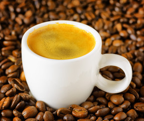 Cup of espresso in coffee beans