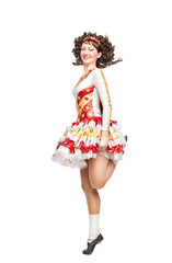 Young woman in irish dance dress dancing isolated