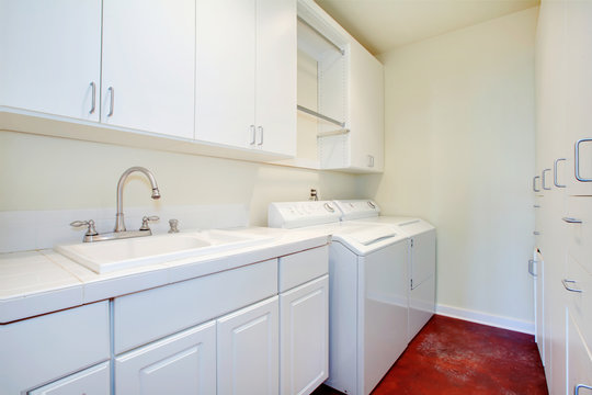 White laundry room with a red floor