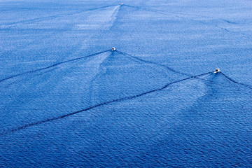 Fishing speedy boat prop wash, white wake on the blue lake © Curioso.Photography