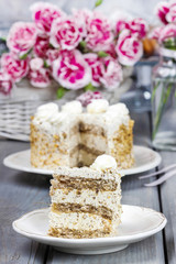 Layer vanilla and chocolate cake. Bouquet of pink carnations