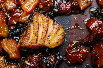 Grilled salmon in herbs on frying pan