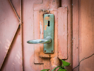 Aluminum door knob on the old door