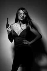 Beautiful brunette girl with a revolver 