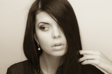 Portrait of a beautiful brunette on a gray background.