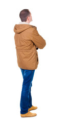 Back view of handsome man in winter parka looking © ghoststone
