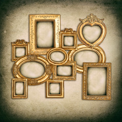 antique golden frames over grungy wall background