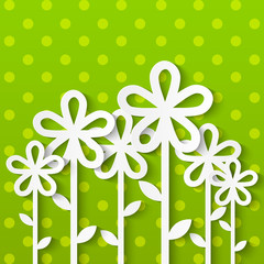 Paper flowers on green background