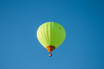 Bright green Air Balloon flying in the blue sky