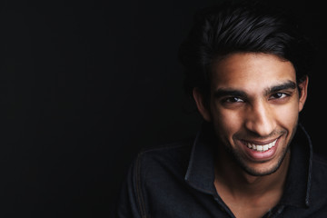 Portrait of a cheerful young man laughing