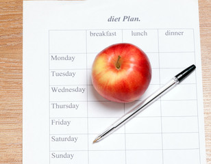 diet Plan. diet plan, pencil and apple lying on a wooden surface