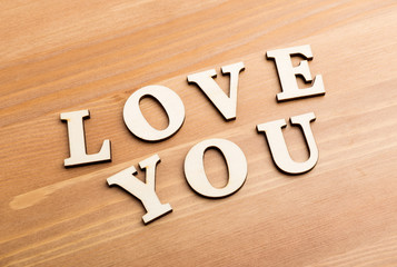 Wooden texture letters forming with phrase Love You