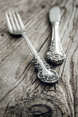old cutlery on wooden table