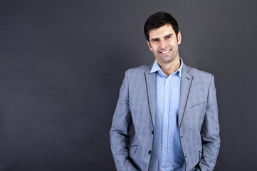 Cool businessman standing on grey background