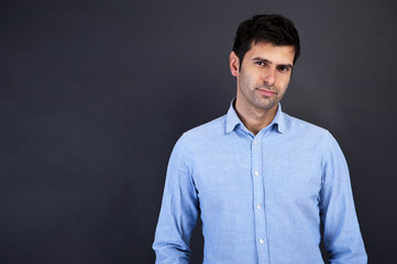 young handsome man smiling over gray background