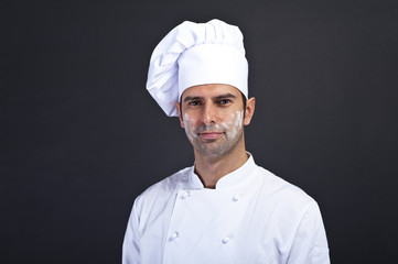 cook men with flour over dark background