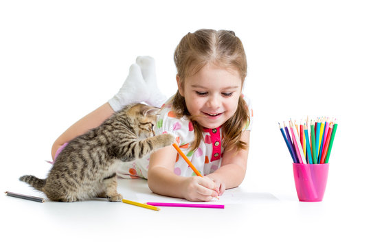 kid girl drawing with pencils and playing with kitten