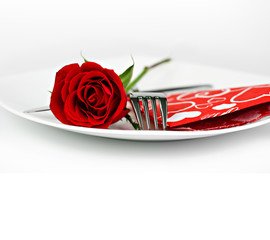 A romantic table setting with rose on a white background