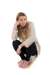 woman student sitting on her books looking bored